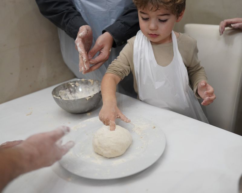 Naples: Pizza-Making Workshop with Drink and Appetizer - Sitting down to eat your own pizza