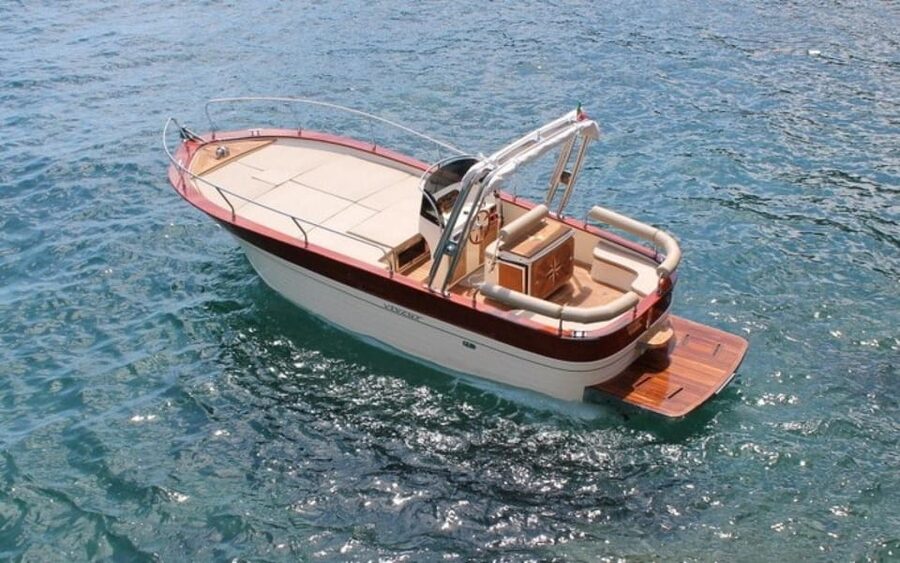 Procida: Boat Tour with Swimming Stops and Underwater Photos - Leaving Marina Grande and passing Palazzo d’Avalos