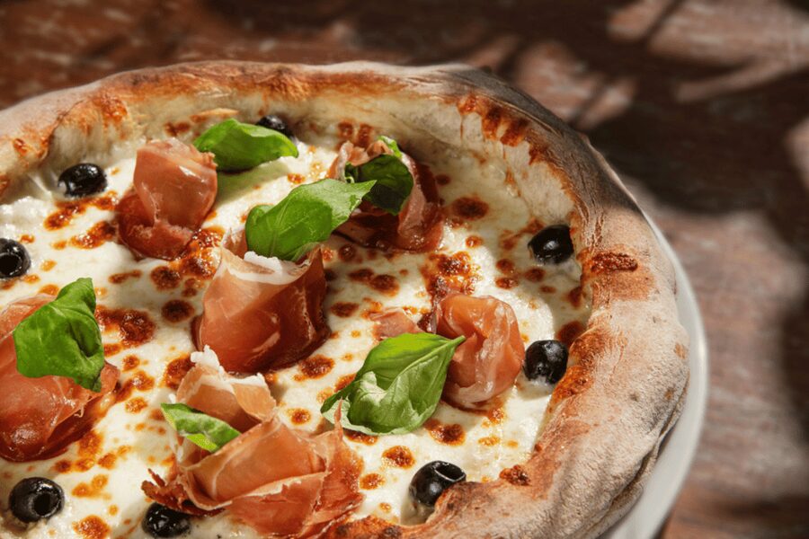 Rome: Traditional Pizza Cooking Class near Piazza Navona - Choosing toppings and using the oven