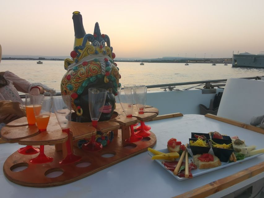 Syracuse: Ortigia Sunset Cruise with Aperitif - Entering the Coral Caves